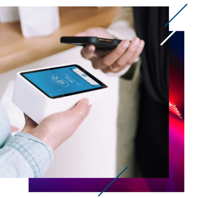 A photograph of a custoner making an NFC payment from a phone to a handheld terminal.