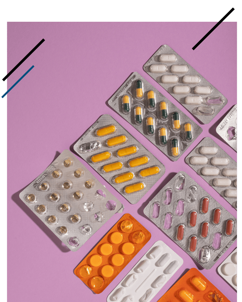 Various pill packages on a purple background